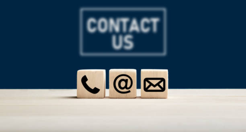 phone-and-e-mail-icons-on-wooden-cubes-with-contact-us-text-on-blue-background-web-page